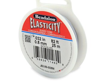 May include: A spool of Beadalon Elasticity Satin Silver elastic cord, 0.032 inches in diameter, 82 feet long. The spool is white with a red label that says "Beadalon Elasticity" and "Elastic Cord".