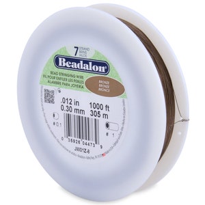 May include: A spool of 7-strand bronze bead stringing wire. The spool is labeled "Beadalon" and has the following information: 0.012 in, 1000 ft, 0.30 mm, 305 m, #0.1, JW01Z-8.