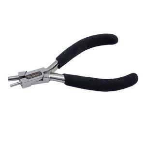 May include: A pair of silver-toned Beadalon brand jewelry pliers with black rubberized handles. The pliers have a unique design with two prongs on one side and a flat surface on the other.