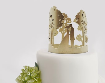 Forest park trees surrounding couple silhouette as a wedding cake crown topper
