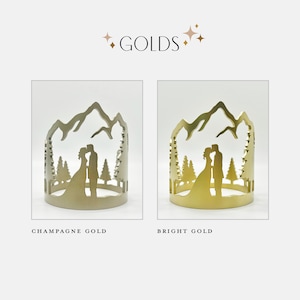 Color options of bright gold and champagne gold cake topper. Bride and groom kissing in the mountains. Colorado, Montana, California, Washington, Wyoming.