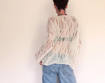 Handmade linen summer sweater with a large, openwork pattern, a boat neckline and long sleeves