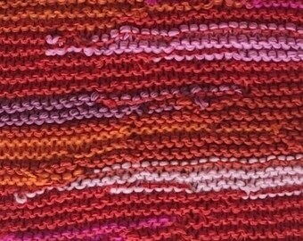 A long and warm scarf from the multicolor line created with shades of pink and orange, a unique handmade piece