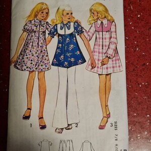 May include: A vintage sewing pattern for a multi-size printed pattern. The pattern is for a dress and pants. The pattern is for sizes 7/8, 9/10, and 11/12 years. The pattern is from the brand Maudella and has the number 5863.
