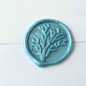 May include: A light blue wax seal with a raised design of a coral branch.