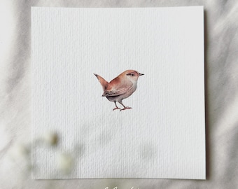 May include: A watercolor painting of a small brown bird with a long tail, perched on a branch. The bird is facing to the right, with its head tilted slightly down. The background is a simple white.