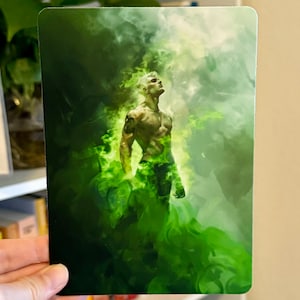 May include: A man stands in a green mist, his body outlined by the swirling smoke. The background is a hazy green, with the man's form the focal point.