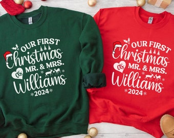 May include: Two Christmas themed sweatshirts, one green and one red, with the text "Our First Christmas as Mr. & Mrs. Williams *2024*" on each.