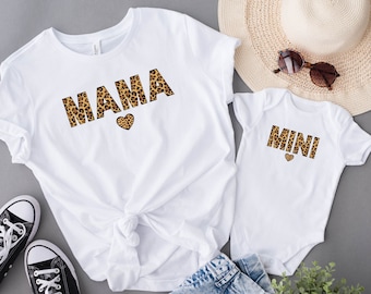 May include: White t-shirts with the words "Mama" and "Mini" in leopard print. The word "Mama" has a small heart next to it.
