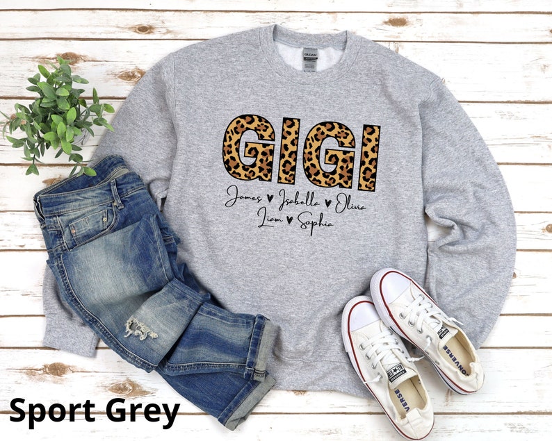 May include: A grey sweatshirt with a leopard print "GIGI" design and the names "James, Isabelle, Olivia, Liam, Sophia" printed below.