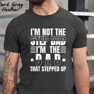 Puede incluir: Camiseta de color gris oscuro jaspeado con texto blanco que dice "No soy el padrastro, soy el padre que dio un paso adelante".