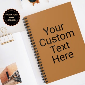 May include: A brown spiral bound notebook with the text "Your Custom Text Here" printed on the front cover.