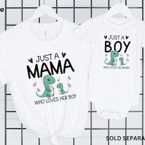 May include: White t-shirts with a dinosaur graphic and text that reads "Just a Mama who loves her boy" and "Just a Boy who loves his mama".