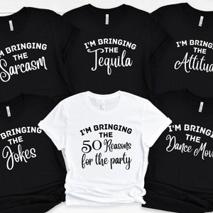 May include: Five black t-shirts with white text. The shirts read "I'm bringing the sarcasm", "I'm bringing the tequila", "I'm bringing the attitude", "I'm bringing the jokes", and "I'm bringing the 50 reasons for the party".