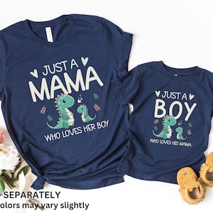 May include: Two navy blue t-shirts with a dinosaur graphic and text that reads "Just a Mama who loves her boy" and "Just a Boy who loves his mama".