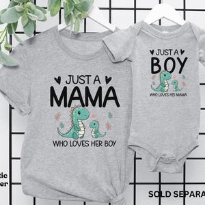 May include: Grey t-shirt with the text "Just a Mama who loves her boy" and a green dinosaur illustration. A matching grey bodysuit with the text "Just a Boy who loves his mama" and a green dinosaur illustration.