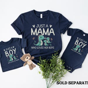 May include: Two navy blue t-shirts with a dinosaur graphic and the text "Just a Mama who loves her boys" and "Just a Boy who loves his Mama".