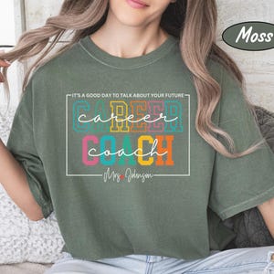 May include: A green t-shirt with the text "It's a good day to talk about your future - Career Coach - Mrs. Johnson" in a white box. The words "Career" and "Coach" are in colourful block letters.