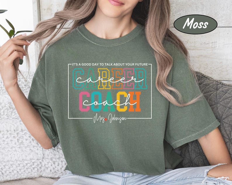 May include: A green t-shirt with the text "It's a good day to talk about your future - Career Coach - Mrs. Johnson" in a white box. The words "Career" and "Coach" are in colourful block letters.