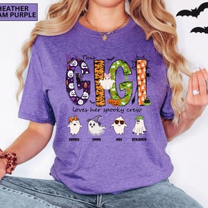 May include: A heather team purple t-shirt featuring the text This GIGI loves her spooky crew. The word GIGI is decorated with Halloween patterns including ghosts, pumpkins, and bats. Below are four cartoon ghosts with names Sophia, Emma, Max, and Benjamin.