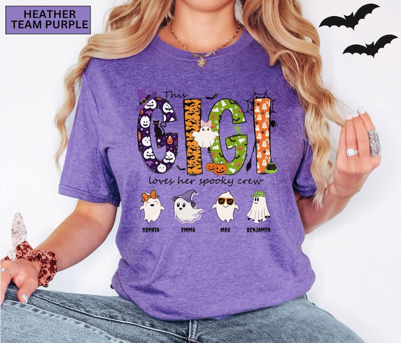 May include: A heather team purple t-shirt featuring the text This GIGI loves her spooky crew. The word GIGI is decorated with Halloween patterns including ghosts, pumpkins, and bats. Below are four cartoon ghosts with names Sophia, Emma, Max, and Benjamin.