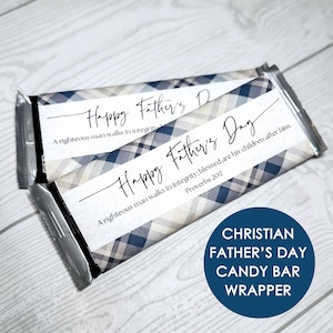 May include: Two rectangular candy bar wrappers featuring a blue, white, and tan plaid pattern. The white center panel displays the text Happy Father's Day in black script, followed by the Bible verse A righteous man walks in integrity; blessed are his children after him. Proverbs 20:7.