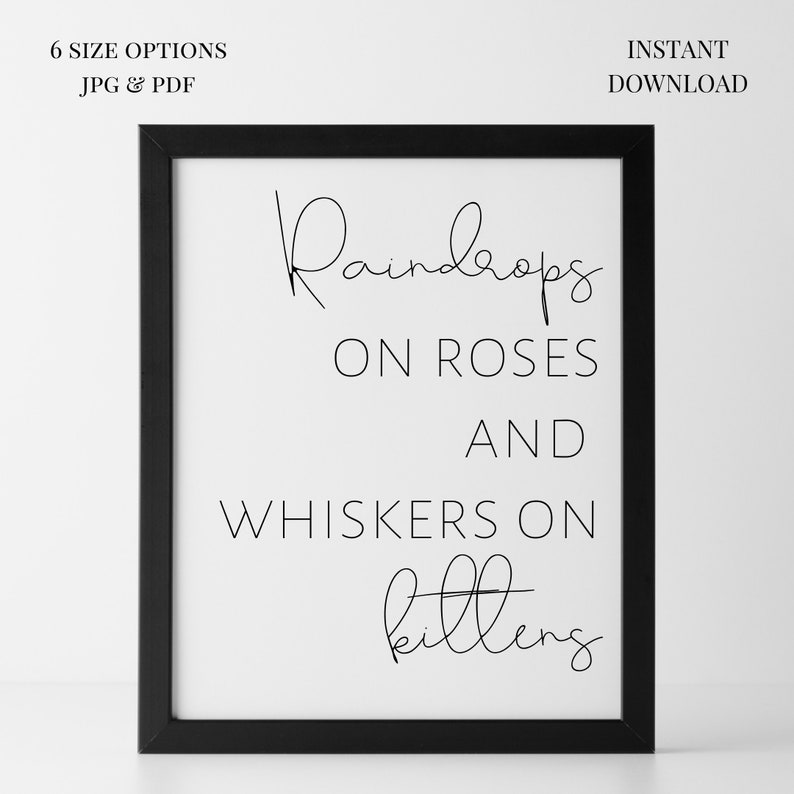 May include: A framed print with the words "Raindrops on Roses and Whiskers on Kittens" in black script. The print is in a black frame and includes the text "6 SIZE OPTIONS JPG & PDF" and "INSTANT DOWNLOAD".