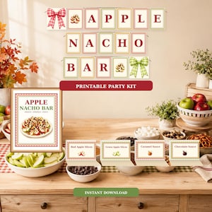 May include: A printable party kit for an Apple Nacho Bar featuring a banner with red text, a framed sign with a graphic of apple nachos, and four food labels for toppings. The design includes red and green bows and checkered borders.