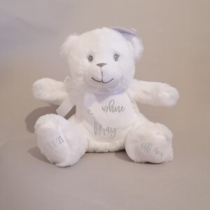 May include: White plush teddy bear with a silver embroidered message that reads "You shine May 01-21 6lb 4oz".