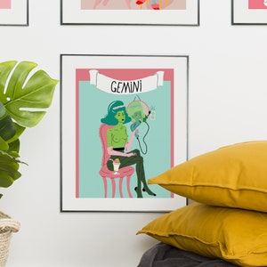 May include: Framed art print with a Gemini zodiac illustration. The artwork shows a green-skinned figure with teal hair, seated and holding a mirror. The word "GEMINI" is displayed above the figure, set against a light blue background.