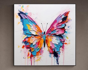 May include: A colorful abstract painting of a butterfly with pink, blue, orange, and yellow wings. The butterfly is painted in a thick, textured style, and the background is white with splashes of color.