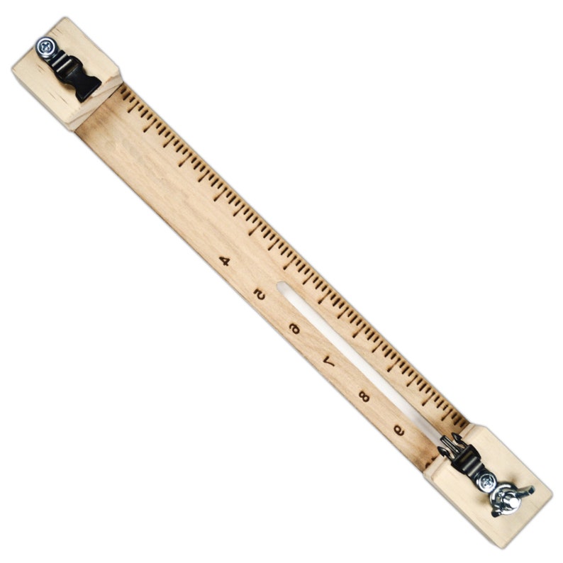 May include: A wooden ruler with two clamps on either end. The ruler has markings in inches from 1 to 9. The clamps have a metal screw and a black plastic piece.