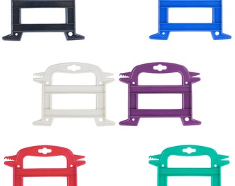 May include: Five plastic cord reels in different colors: black, blue, white, purple, and red. Each reel has two horizontal bars and a handle on top.