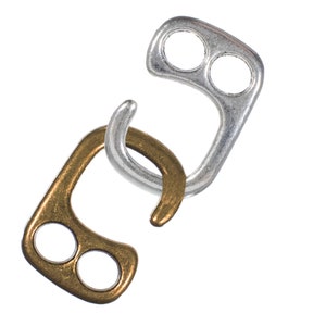 May include: Two metal hooks, one gold and one silver, with two holes each. The hooks are interlocked.