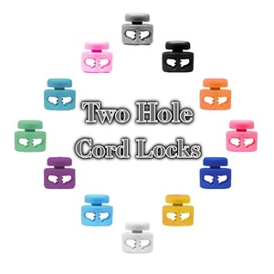 May include: Assortment of two-hole cord locks in various colors, including grey, pink, black, orange, light green, purple, light blue, yellow, and white.  Two Hole Cord Locks.