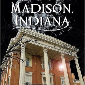 May include: A book cover titled Ghosts of Madison, Indiana by Virginia Dyer Jorgensen. The image features a large, multi-story brick building with white columns under a dark night sky with a prominent full moon and bare tree branches.