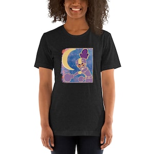 May include: A black t-shirt with a graphic print of a purple cartoon character wearing boxing gloves and a yellow crescent moon in the background.