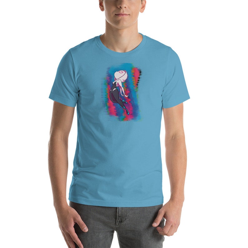 May include: A light blue t-shirt with a graphic print of a cartoon character in a black and white suit, with a white head and pink and blue hair, against a colorful background.