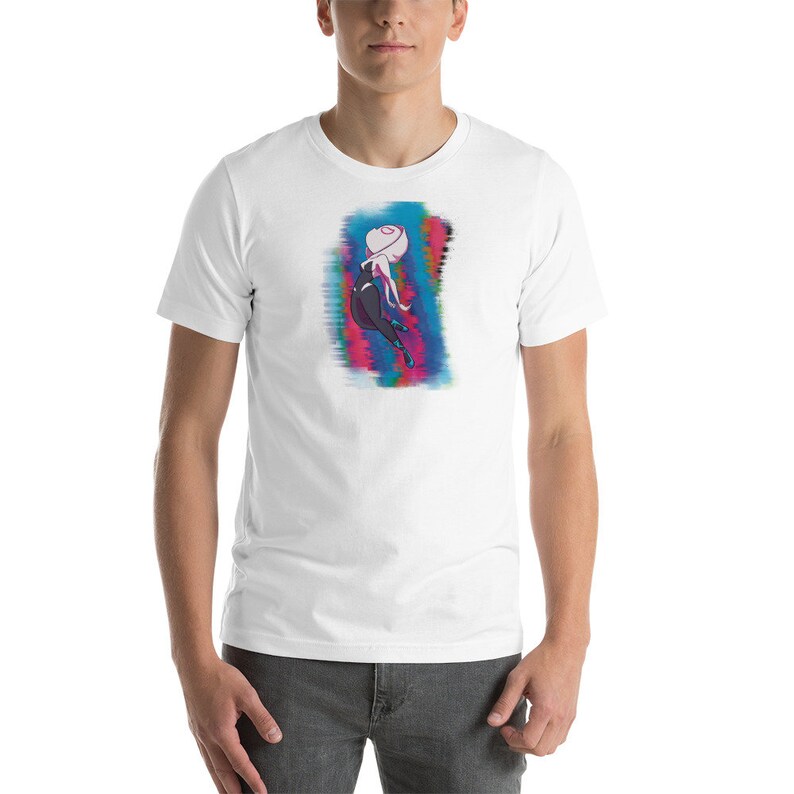 May include: White t-shirt with a colorful graphic of a female superhero in a black suit with a white spider symbol on her chest. The superhero is in a dynamic pose with her arms and legs outstretched.