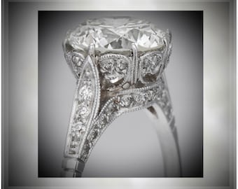 May include: A silver engagement ring with a large, round, clear diamond set in a detailed, ornate, floral design.