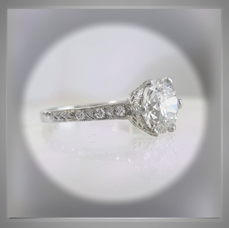 May include: A silver engagement ring with a large, round, clear diamond center stone and smaller diamonds set in the band.