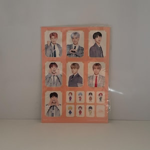 May include: A rectangular peach-colored sticker sheet featuring seven individual photographic portraits of young men in suits, arranged in a grid, alongside eight smaller cartoon-style character illustrations of the same individuals.