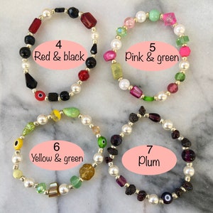 May include: Four bracelets with different colored beads. The bracelets are made with white pearls and various colored glass beads. The bracelets are labeled with numbers and color combinations: 4 Red & black, 5 Pink & green, 6 Yellow & green, 7 Plum.