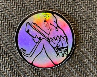 May include: A holographic sticker featuring a colorful illustration of a jester reading a book. The sticker has a black outline and a rainbow background.