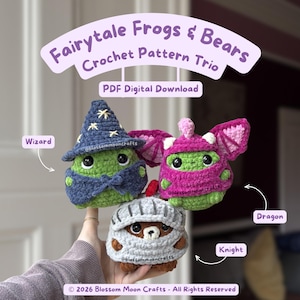 May include: Three crocheted plush figures labeled Fairytale Frogs & Bears Crochet Pattern Trio PDF Digital Download. One green frog wears a blue wizard hat, one green frog has pink dragon wings, and one brown bear wears a grey knight helmet.