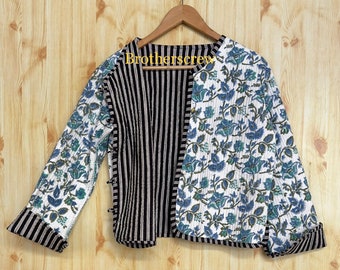 May include: A quilted jacket with a floral pattern in blue and green on a white background. The jacket has a black and white striped panel down the center and black and white striped cuffs. The text "brotherscrew" is visible on the hanger.