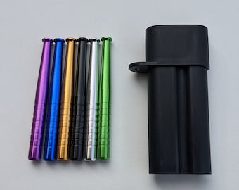 May include: A set of seven colorful metal smoking pipes with a black carrying case. The pipes are purple, blue, gold, black, silver, and green.