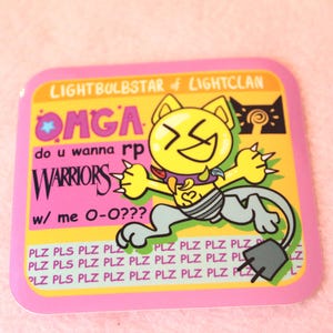 May include: Square sticker with a cartoon cat character in yellow, gray, and pink. The cat has a large grin and is surrounded by text that reads "LIGHTBULBSTAR of LIGHTCLAN" and "WARRIORS". The sticker has a pink border.