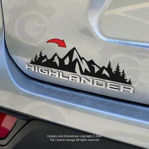May include: Black mountain and forest decal with the word "HIGHLANDER" in silver lettering. A red arrow points to the mountain graphic. The decal is affixed to a silver vehicle.