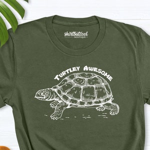 May include: A green t-shirt with a white turtle graphic and the text "TURTLEY AWESOME" printed on the front.